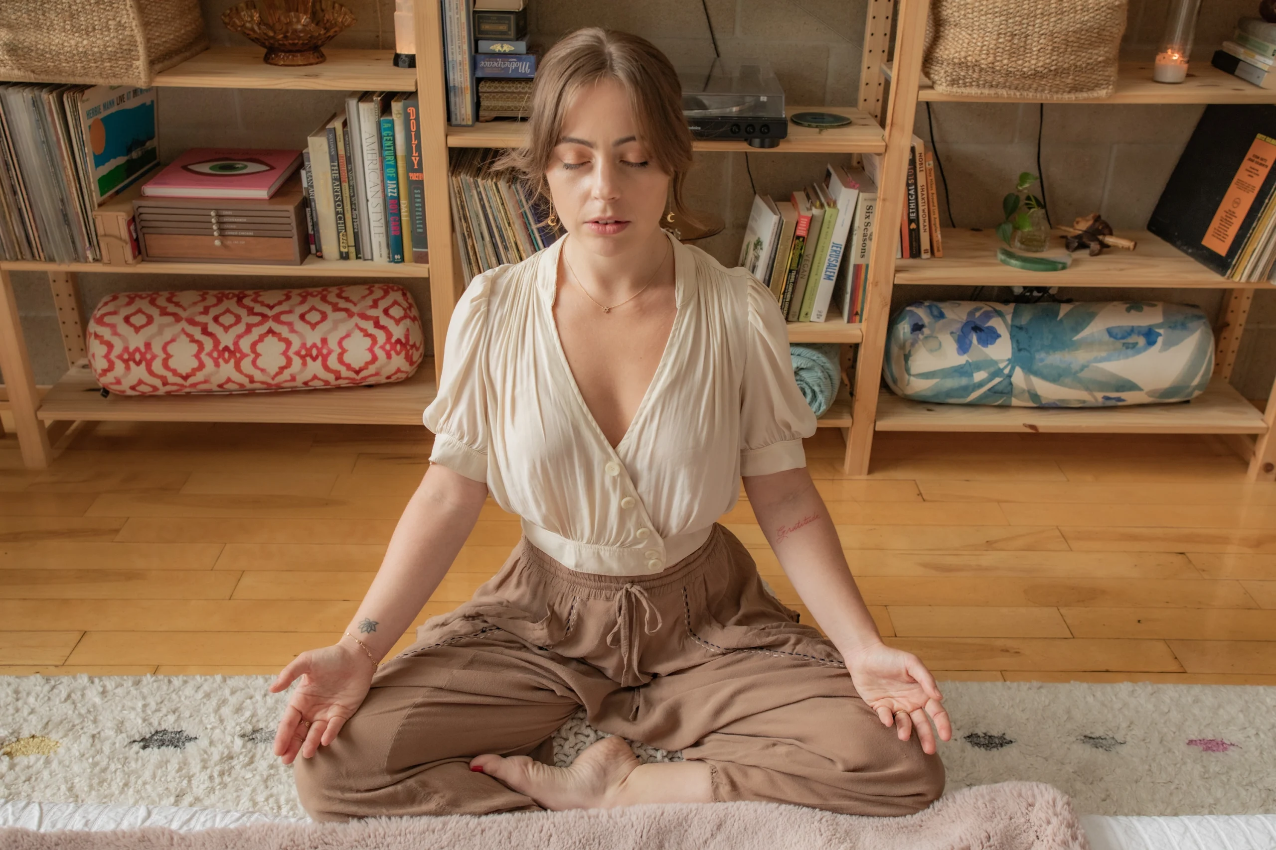 A client in calm seated meditation during a reiki session at the Word of Mouth Melrose studio in West Hollywood